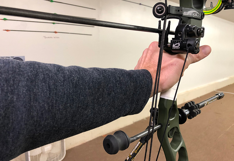 bowhunter shooting with tacky bow grip