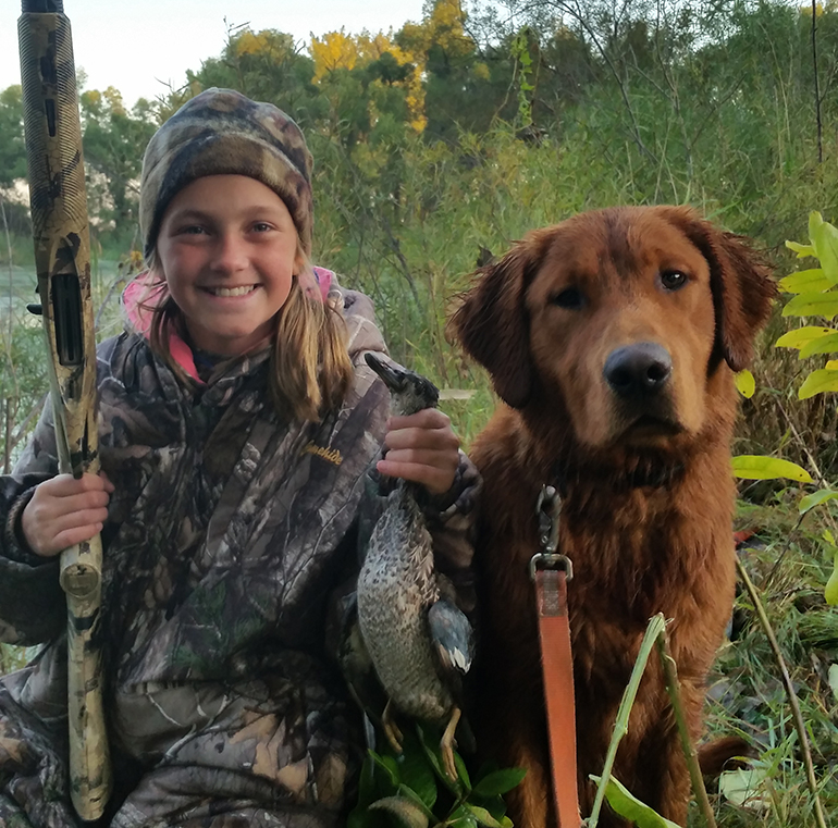Kamryn with her first duck and dog Fawkes