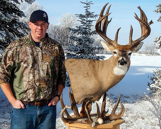 Justin Berg with whitetail mount and sheds