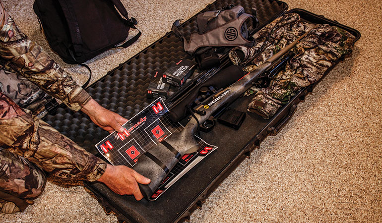 hunter packing deer rifle case