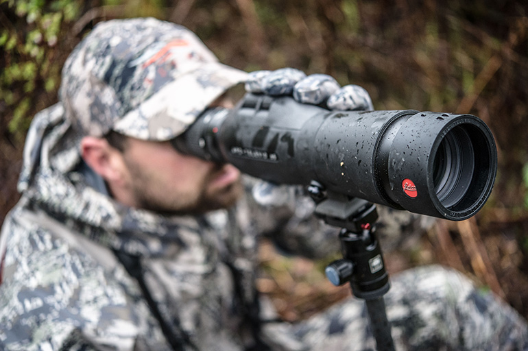 closeup of hunter looking through Leica spotting scope