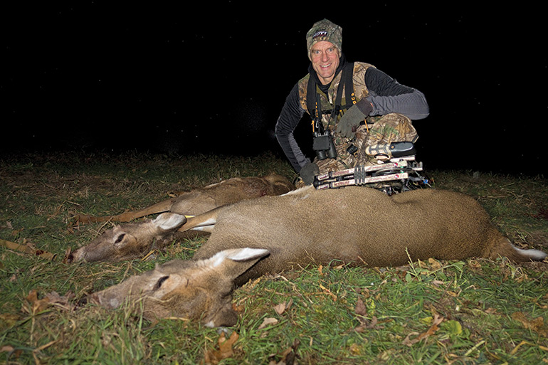 Bill Winke with a pair of archery does at night