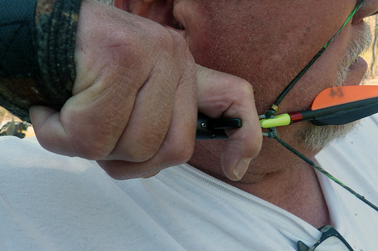 man holding index finger release aid