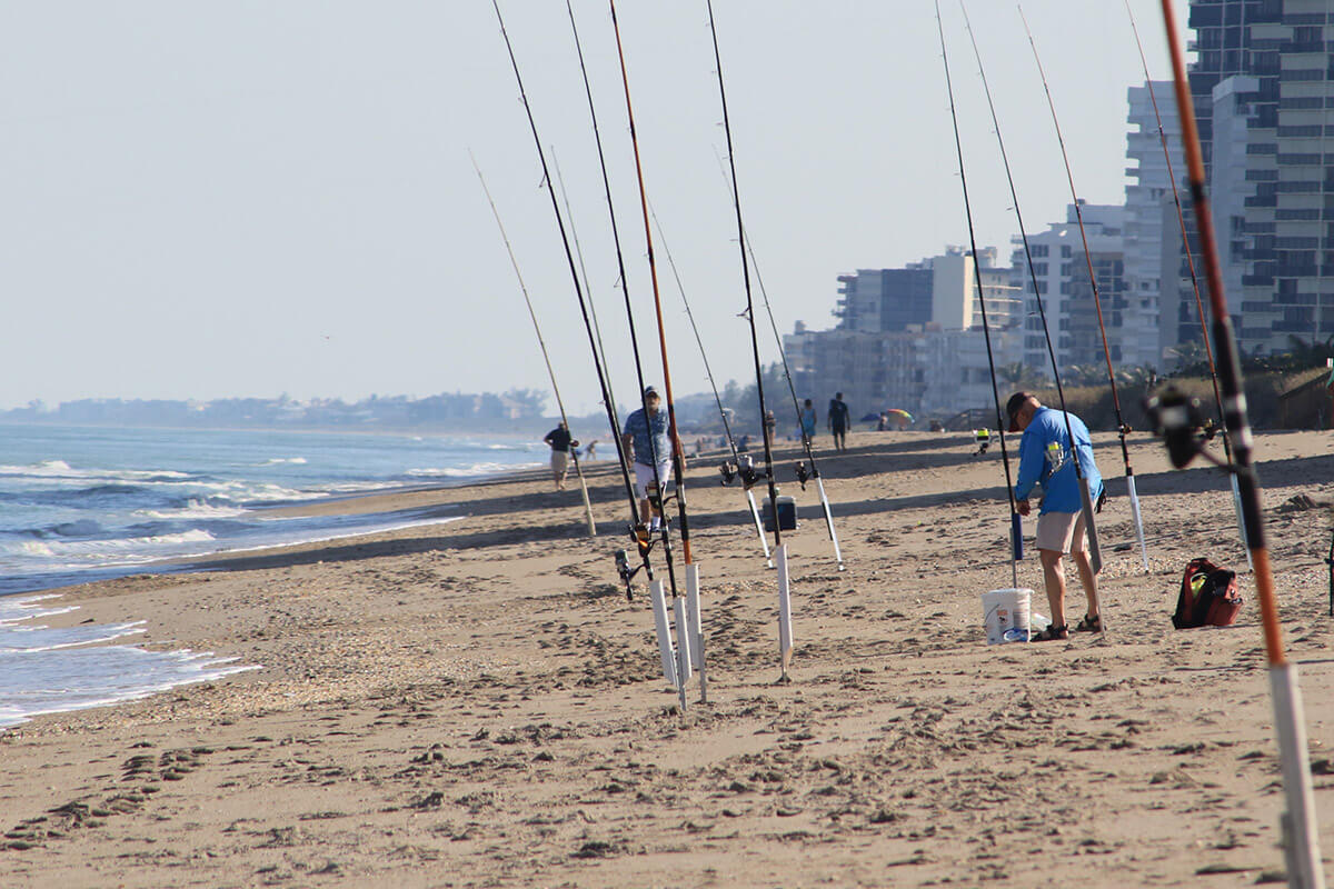 surf fishermen and rods on the beach