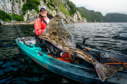 adam fish with a 156 pound halibut on his kayak