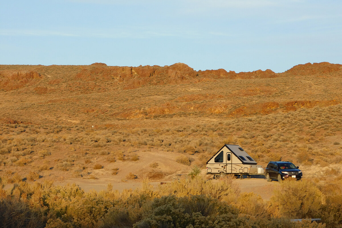 car and camper in desert