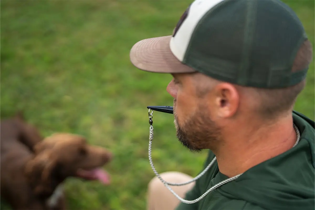 dog trainer with whistle