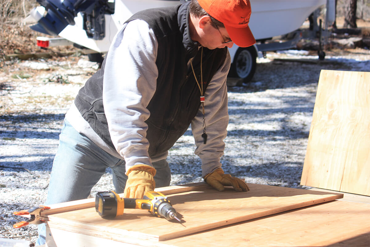 man building a whelping box