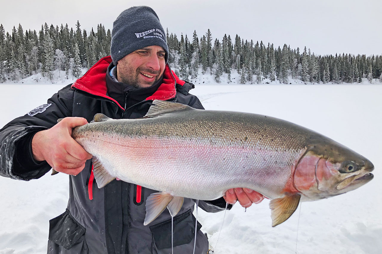 Ice fishing for rainbow trout at Wekusko Falls Lodge