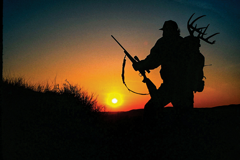 https://content.osgnetworks.tv/northamericanwhitetail/content/photos/Hunter-Packing-Out-Sunset-lead.jpg