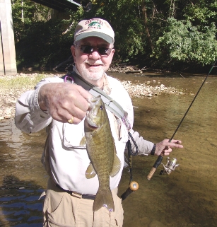 Dr. Larry Kelley, of Richmond, Ky., holds a smallmouth caught on Buck Creek in Kentucky. Buck Creek offers incredible scenery comprised of bluffs, caves and crystal clear water. The creek also has bountiful populations of smallmouth and rock bass.