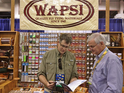 Karl Schmuecker (left), general manager of Wapsi Fly in Mountain Home, Ark., visits with Tight Lines Ltd. representative Peter Toynbee of Napier, New Zealand