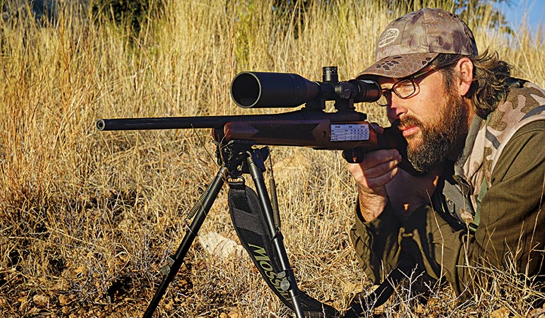 David Draper shooting rifle in desert