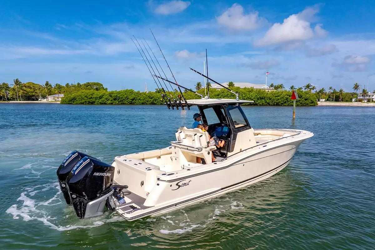 Twin black outboards on white center console fishing boat
