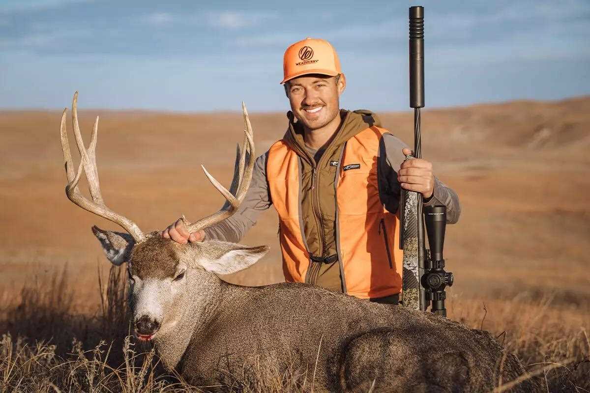 hunter with muley buck