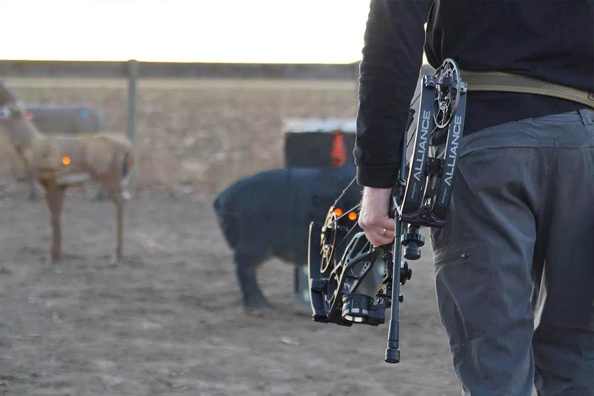 archer walking with his bow towards target