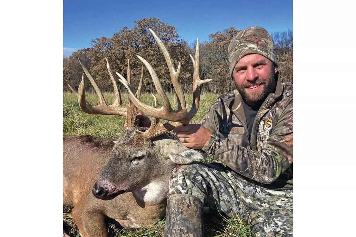deer hunter with big whitetail buck