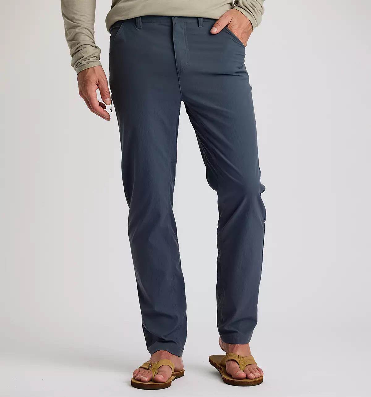 Studio photo of a male model wearing navy blue pants.