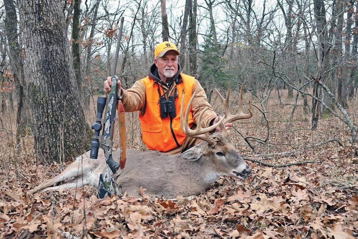 hunter with whitetail buck