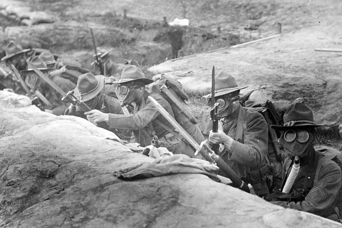 U.S. troops training in a trench with bayonets affixed to their rifles during World War I.