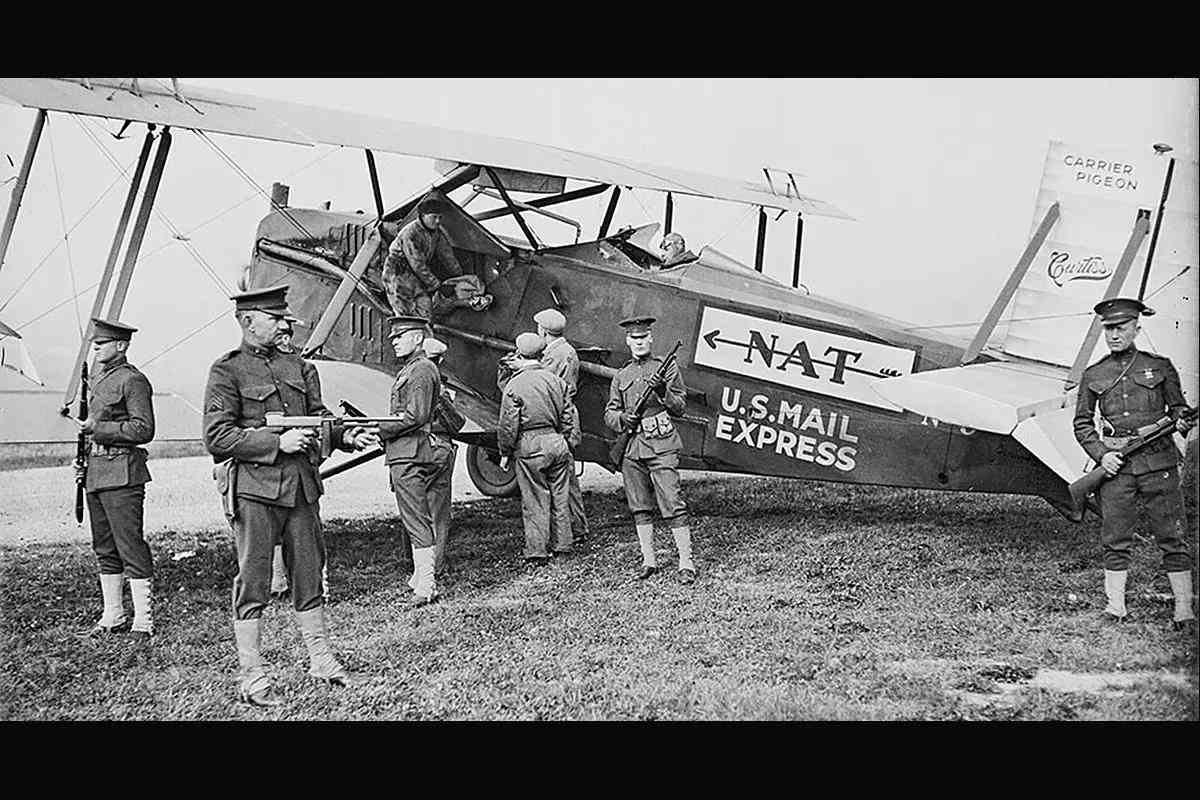 Marines with Trench Guns and a Thompson guarding the U.S. Mail as it is loaded into a 1920s vintage biplane.