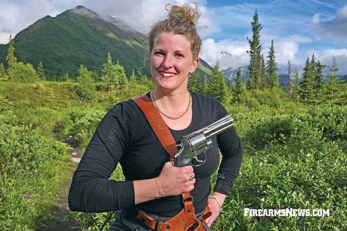 Girl posing with revolver and holster
