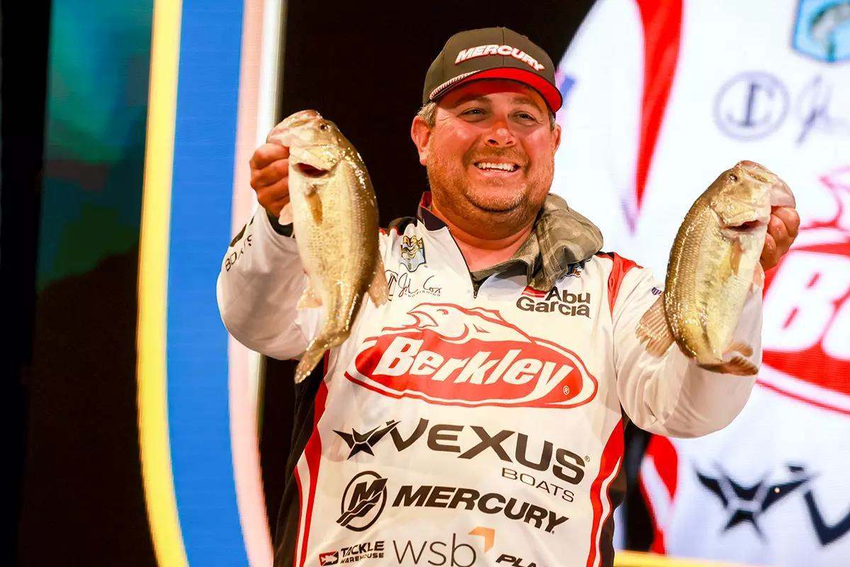 photo of man on stage at fishing tournament
