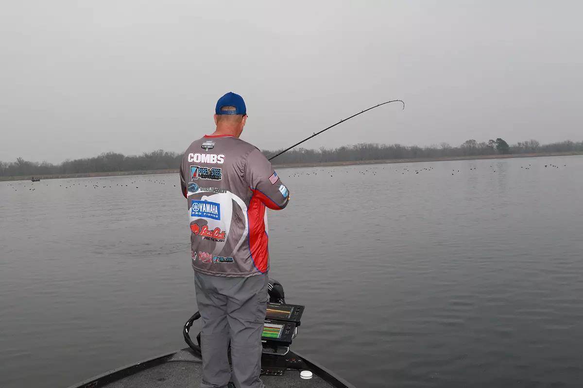 man fishing from bass boat