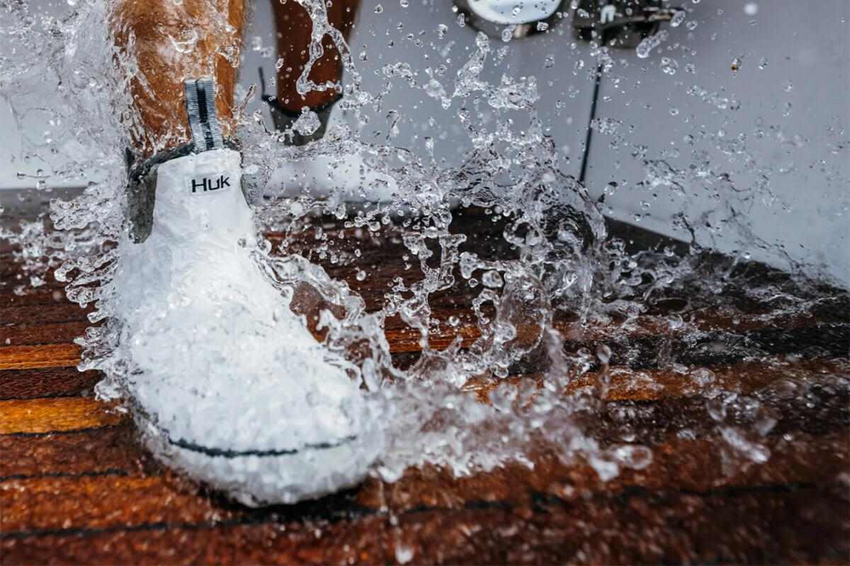 water splashes onto huk rogue wave waterproof fishing boots