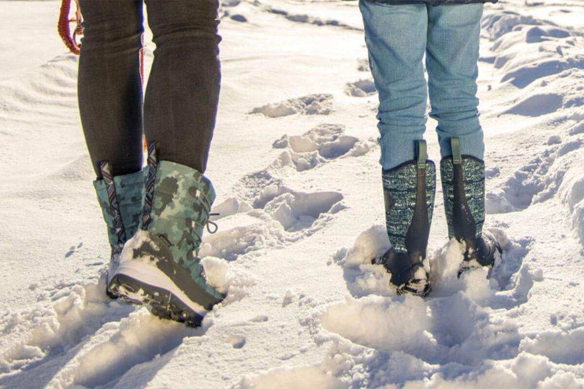 close up of womens and kids boots walking in snow