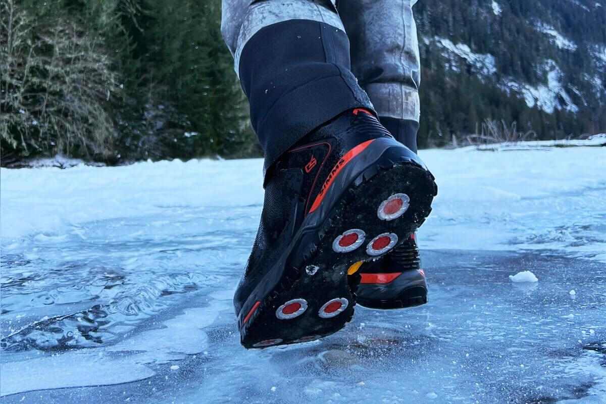 close up of felt boots with cleats walking on ice
