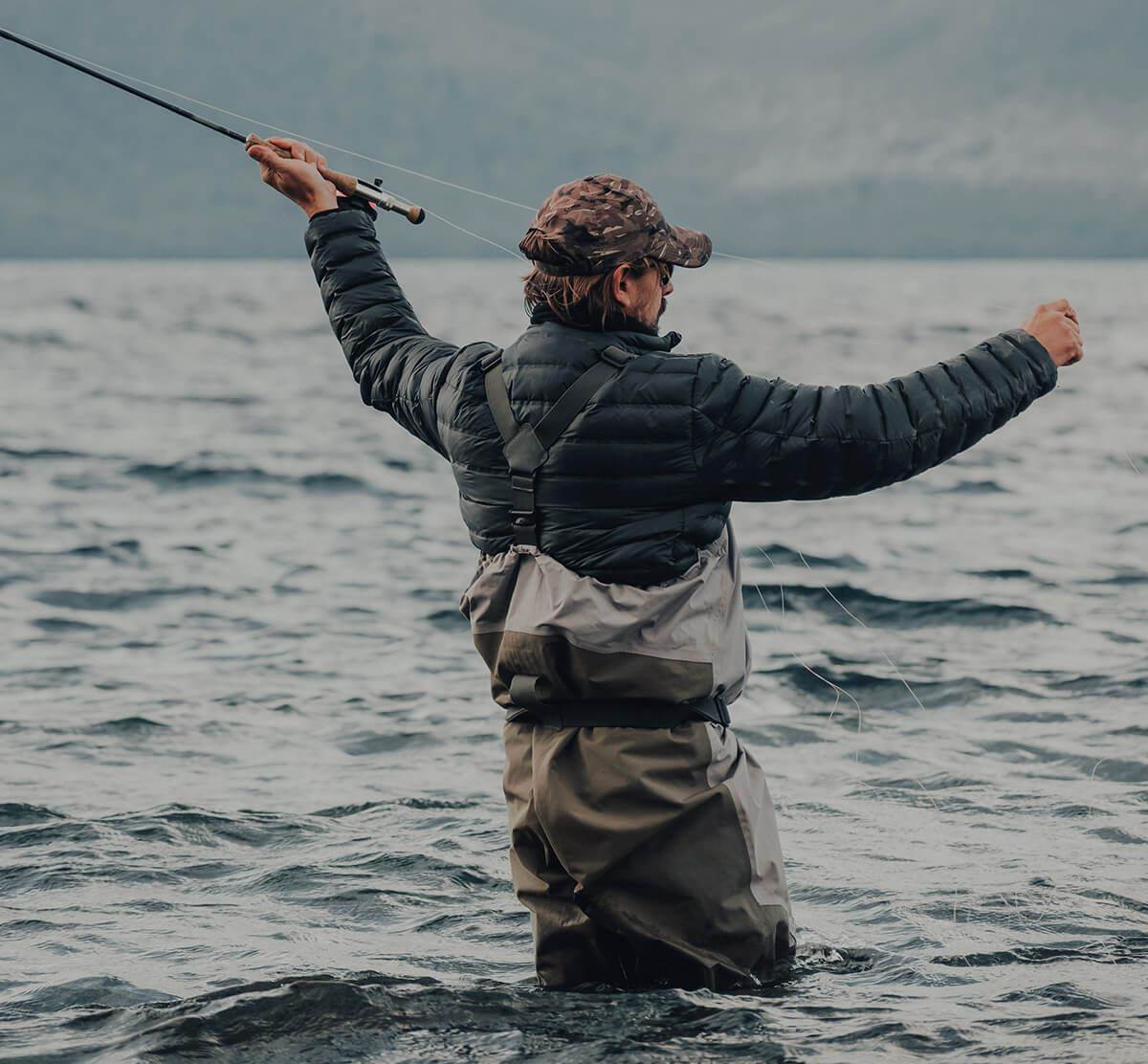 wading fly fishermen casting in thigh deep water