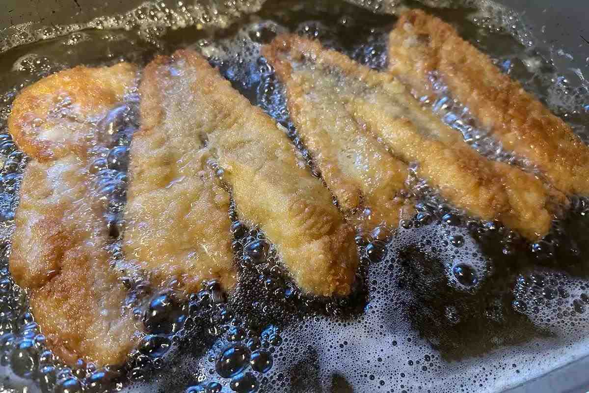 fish frying in pan