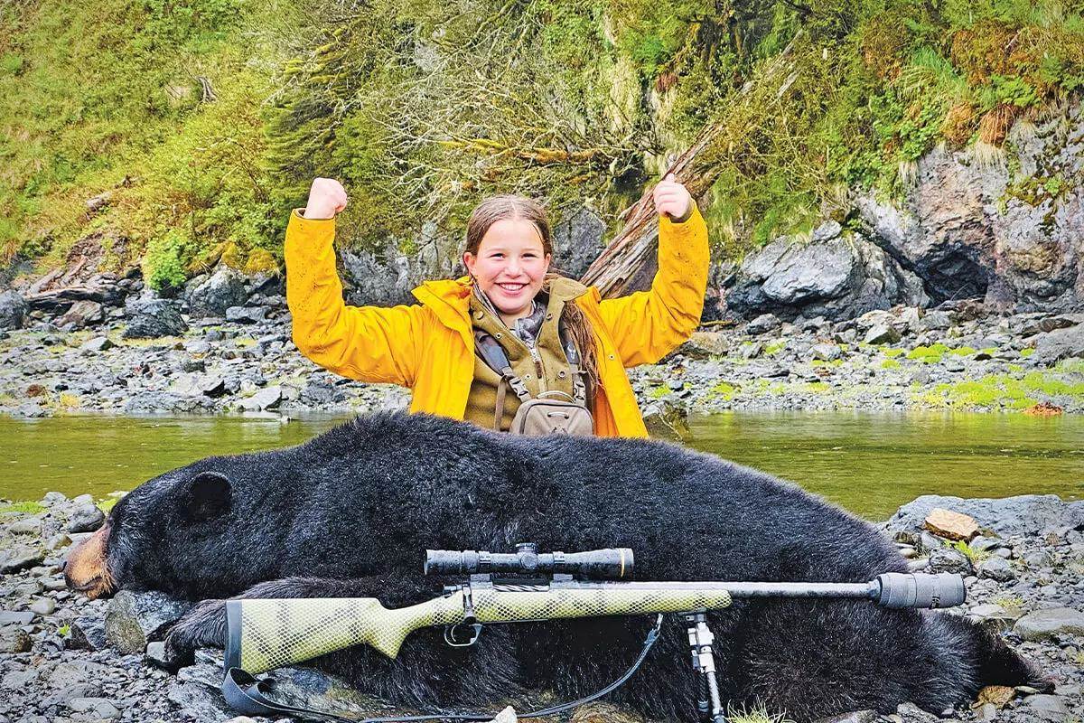 youth hunter with bear