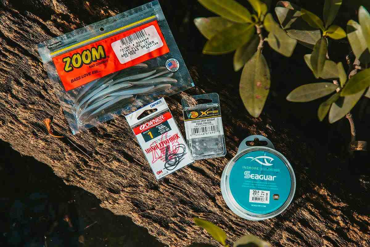 bag of zoom hooks jerkbaits and 20lb seaguar leader on a tree branch