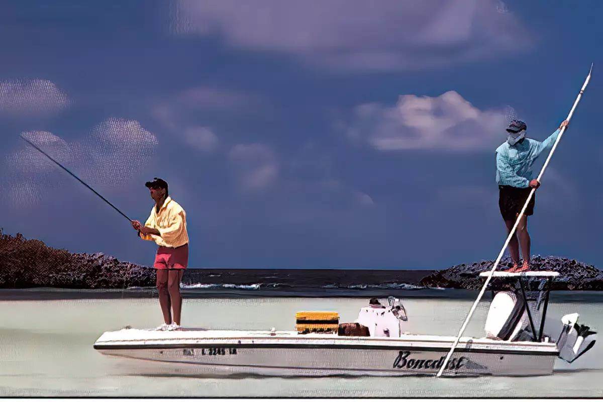 A fly angler and guide fishing from a flats boat. 