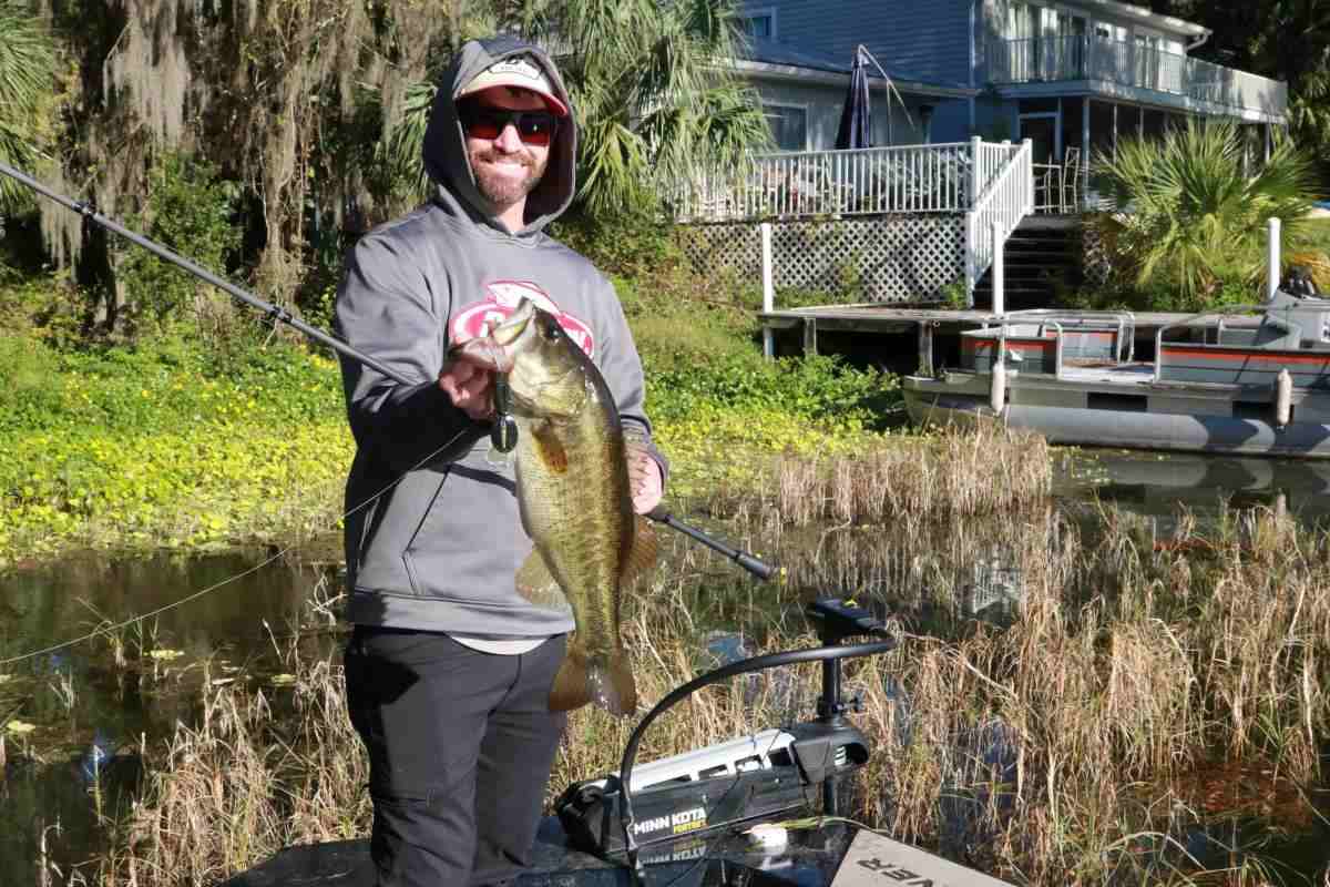 Angler Keith Carson holds up a largemouth bass caught while pitching. 
