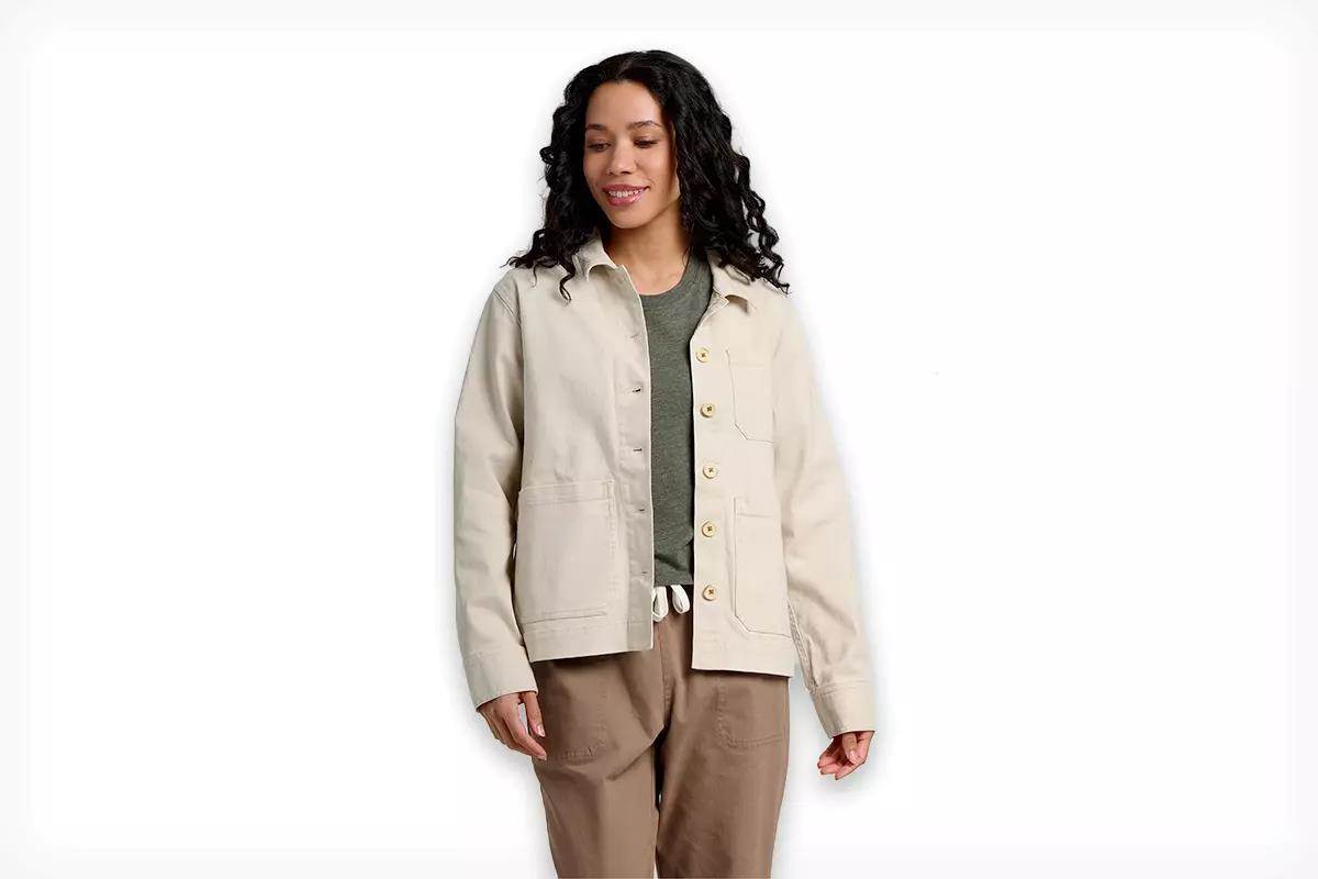 A model wearing a light cream-colored coat, the Free Fly Folly Twill Chore Coat.