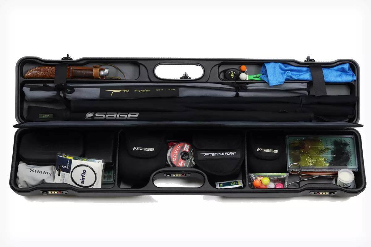 Studio photo of a fly-fishing travel case open and full of gear.