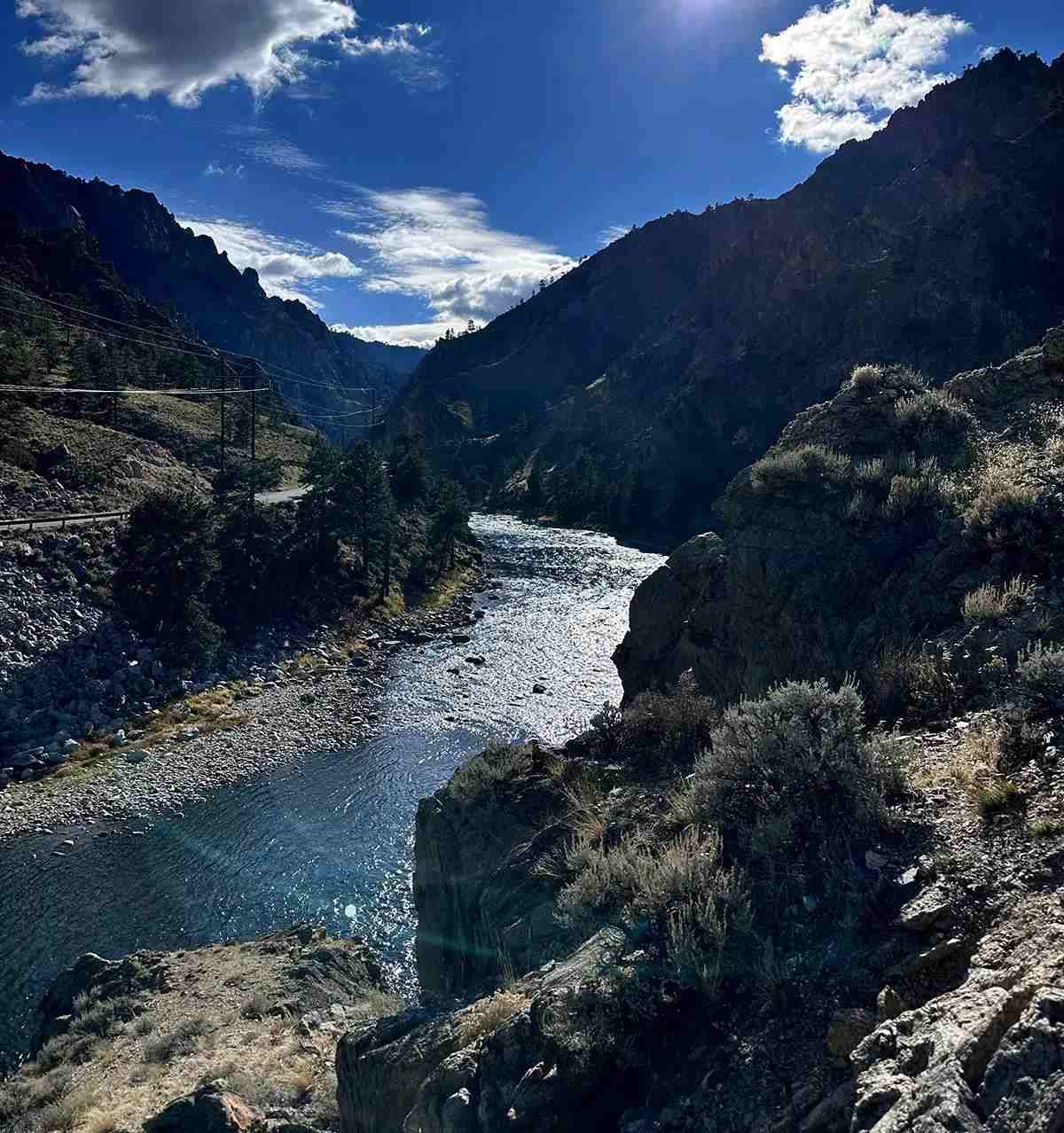 A sun-kissed river flowing through a desert canyon. 