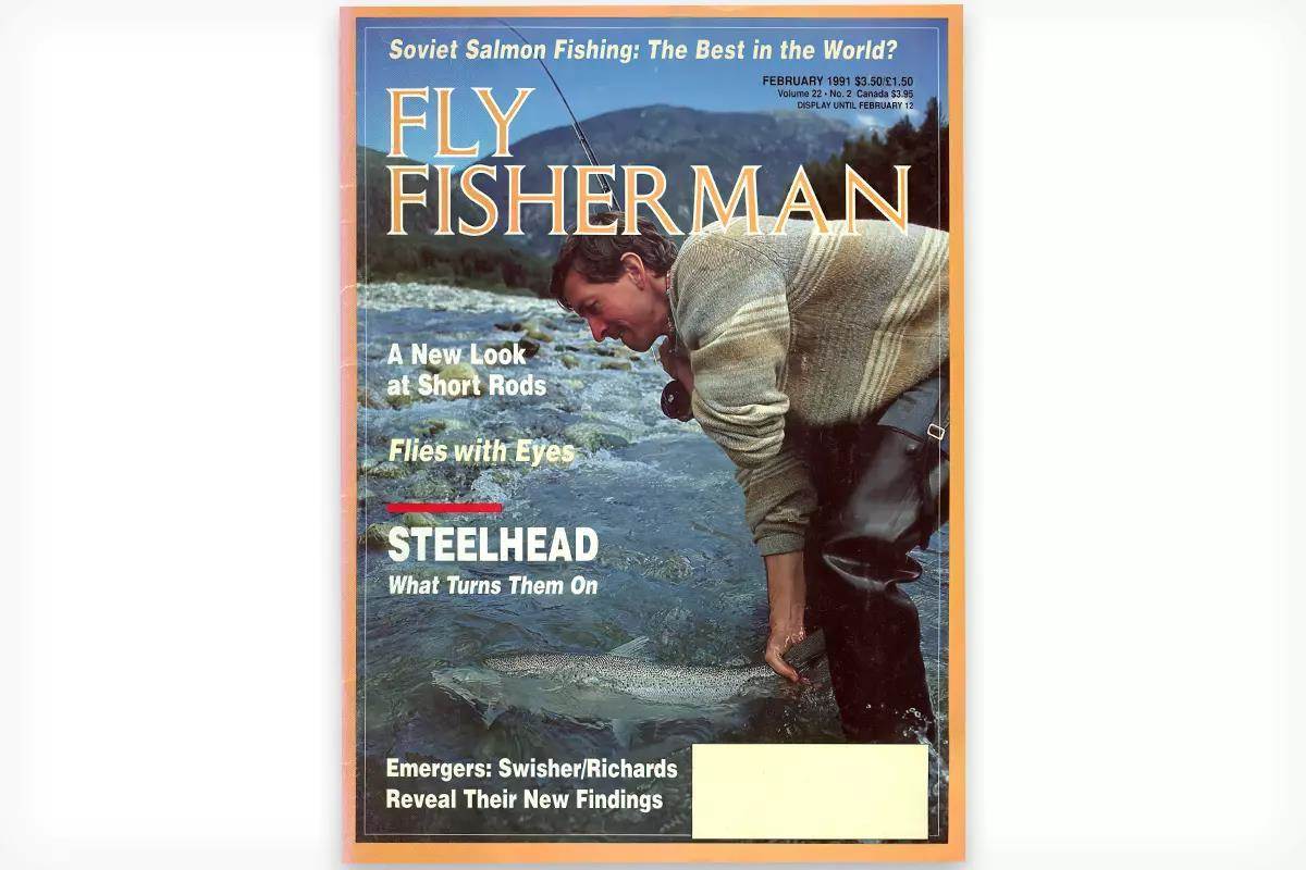 The cover of the February 1991 issue of Fly Fisherman magazine showing a man wading in a river releasing a steelhead. 