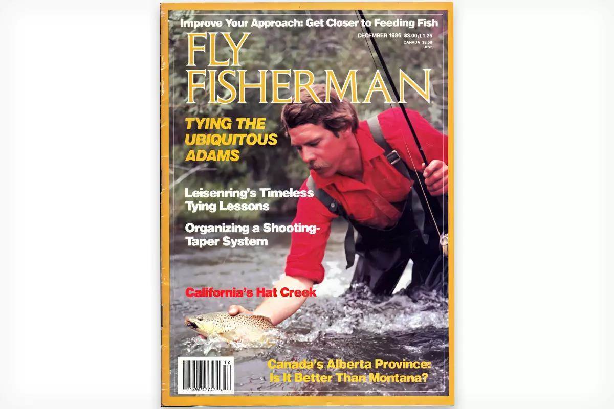 A fly angler leaning over wading knee deep releasing a brown trout. 