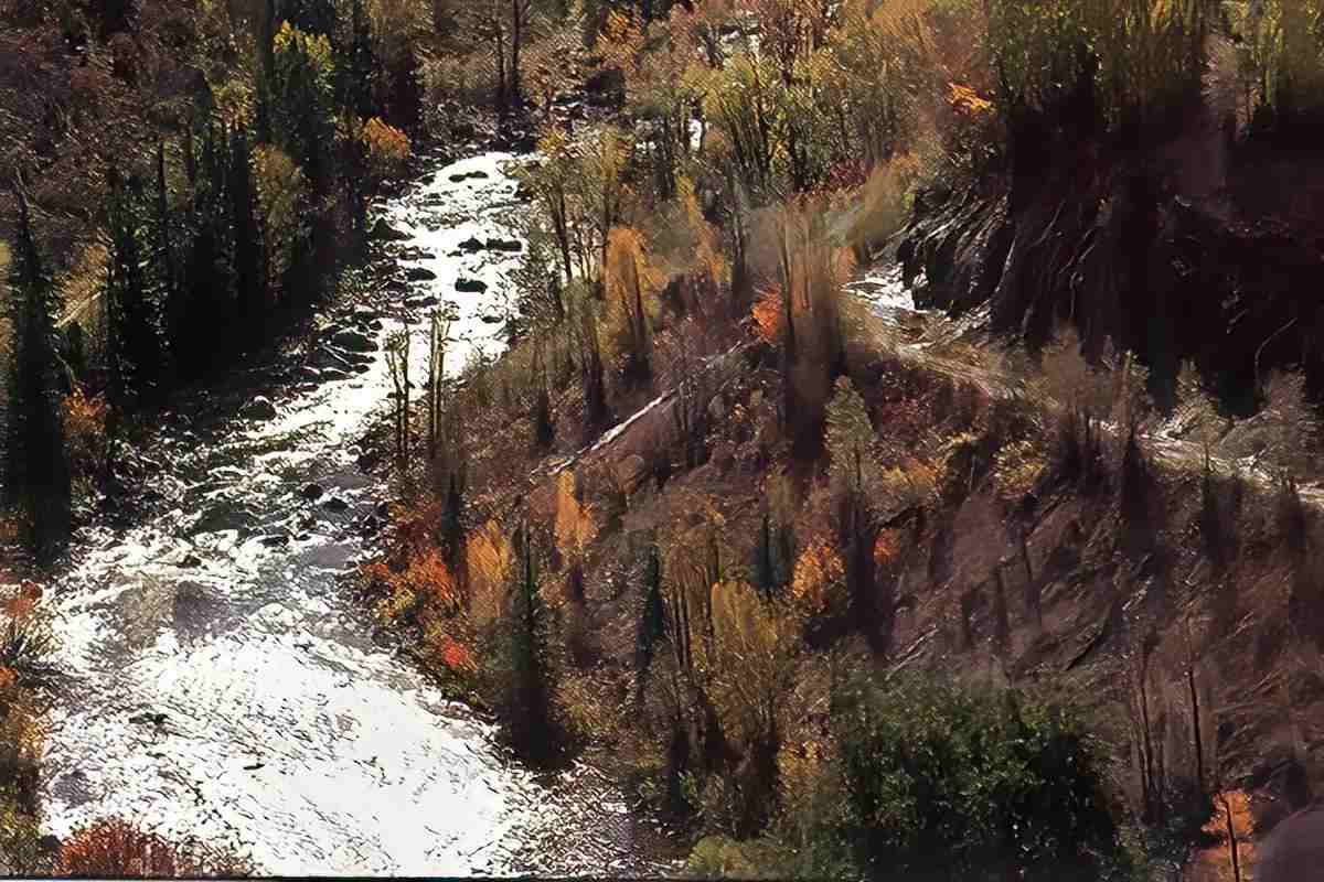 An aerial photo of a canyon section of a rocky river. 