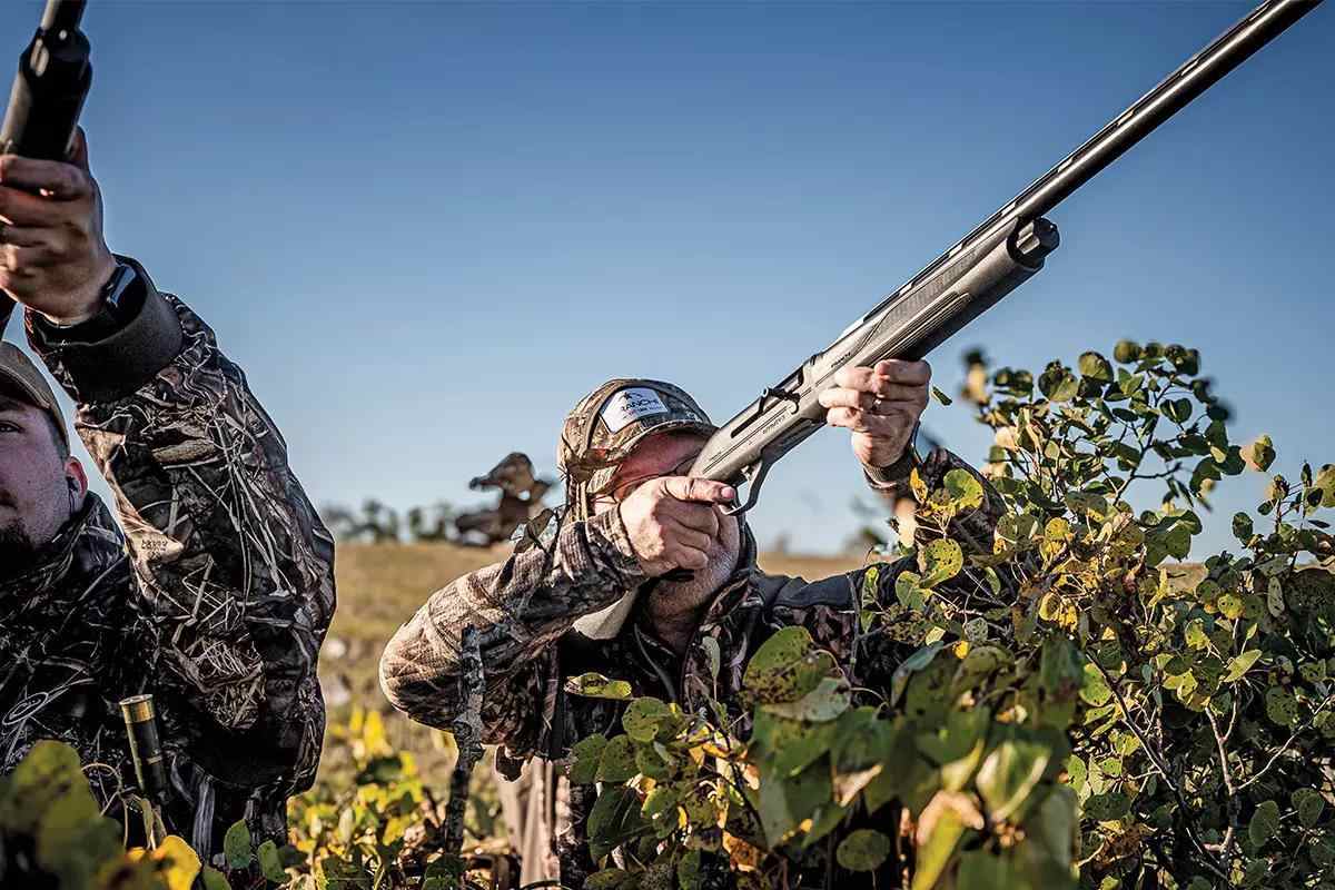A hunter shoulders the Franchi Affinity shotgun, ready to shoot it.