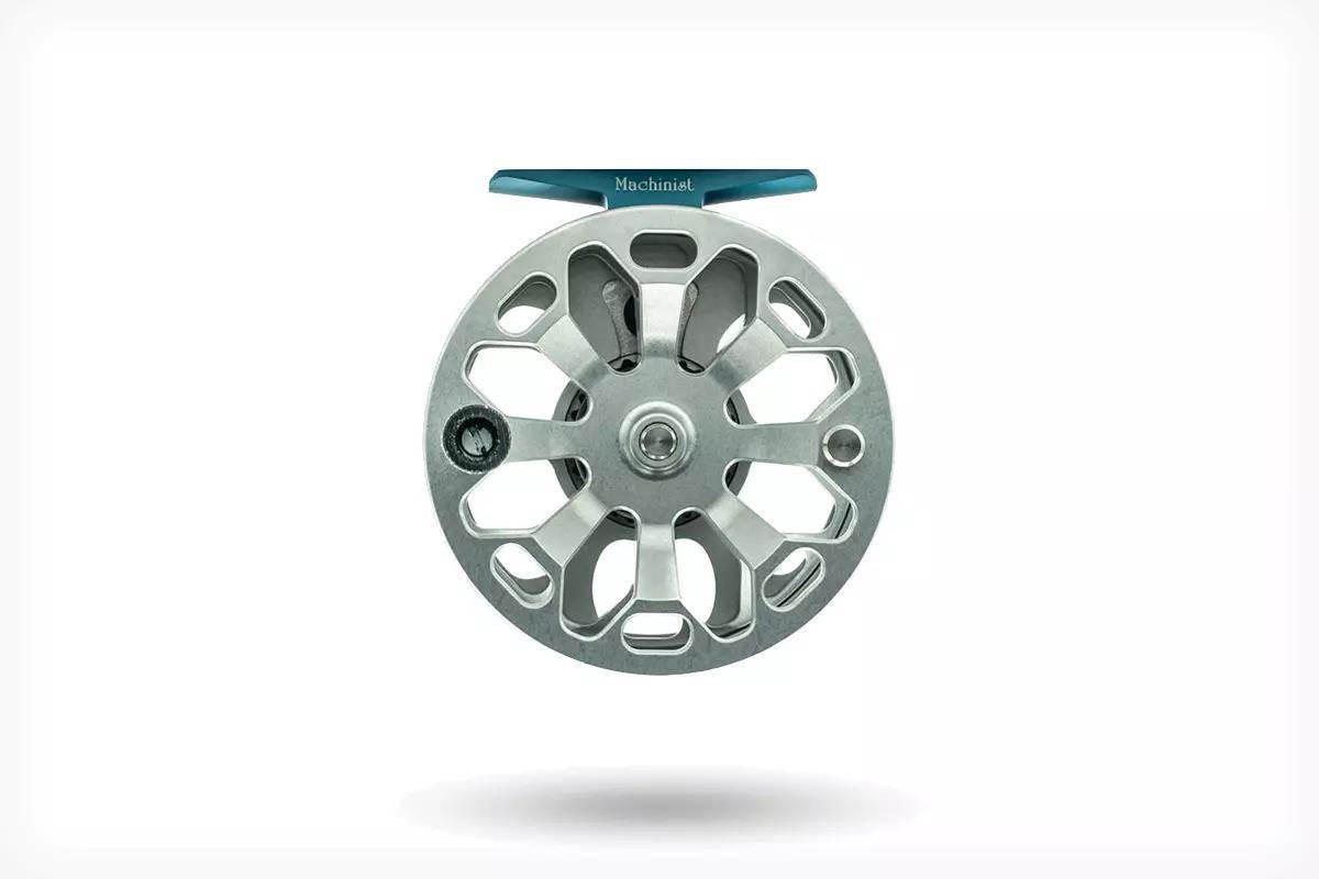 Studio photo of a silver fly reel.