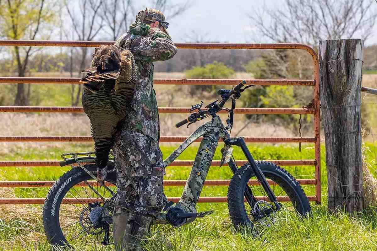 Hunter with electric bike and bagged turkey.