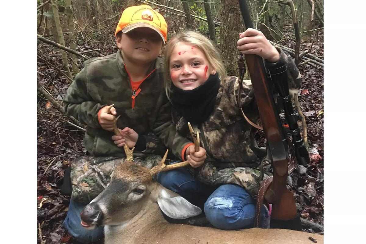Young hunters with small harvested deer.