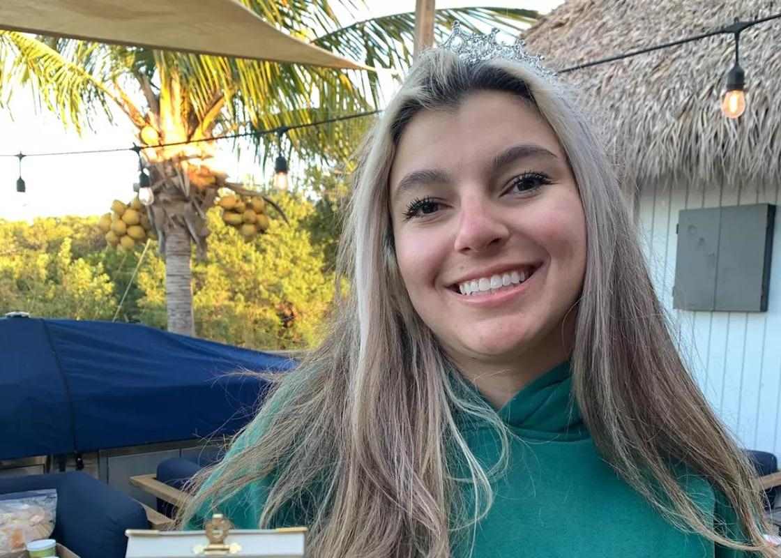 Young woman holds award