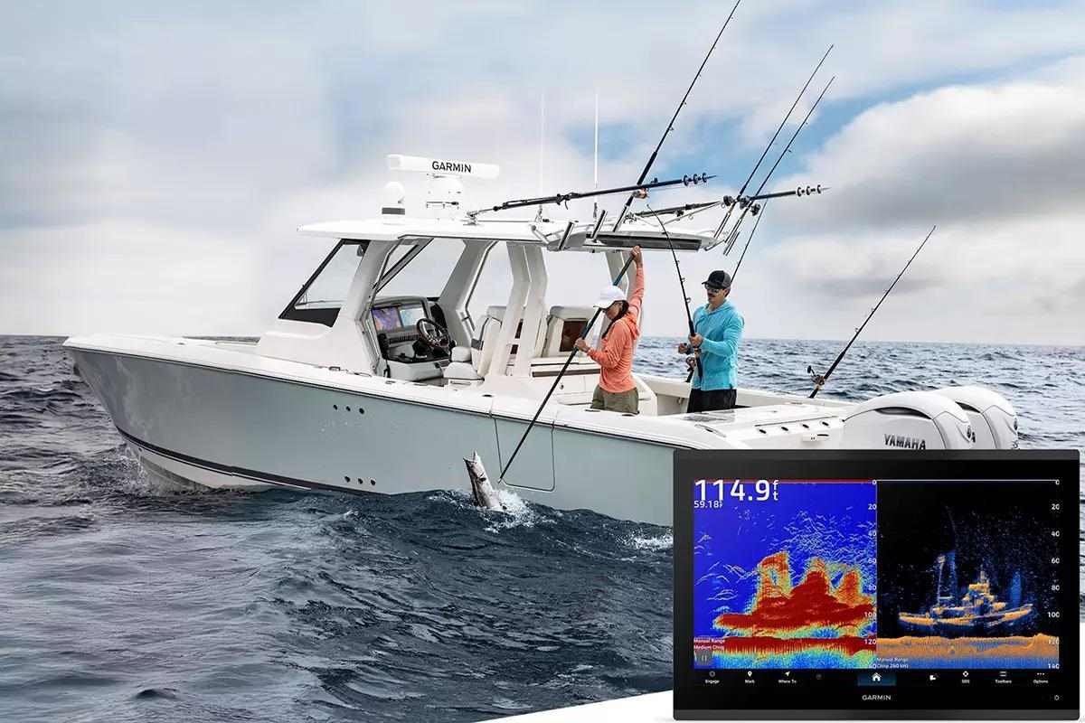 white boat with two anglers landing fish one holding gaff the other a rod