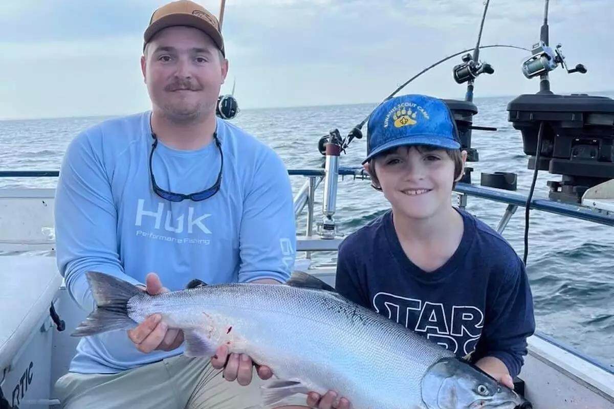 A large coho salmon caught by a boy, 7